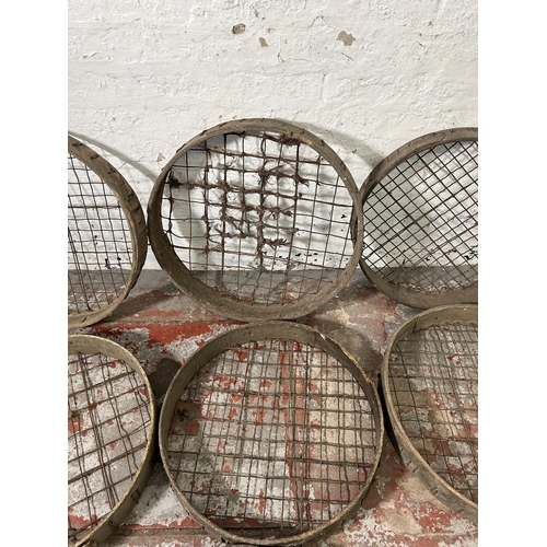 162 - Seven antique wooden and metal wired potato picking baskets - largest approx. 62cm high