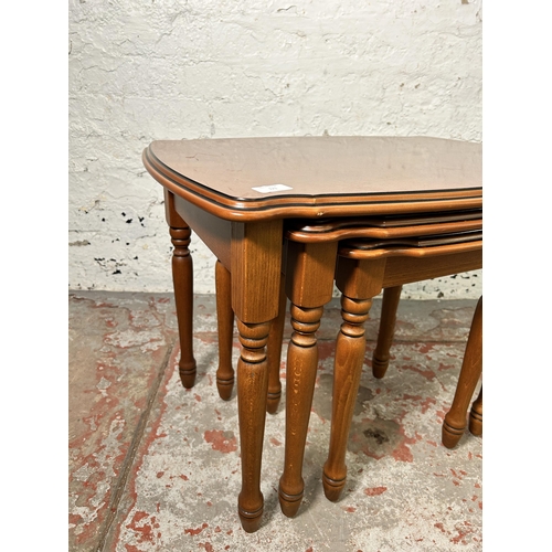 171 - A French style cherrywood nest of tables - approx. 50cm high x 66cm wide x 47cm deep