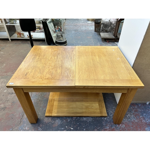 183 - A modern solid oak extending dining table - approx. 77cm high x 90cm wide x 132cm long not extended