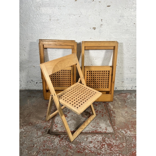 184 - Five contemporary oak folding chairs to include one stamped made in Italy by Magis