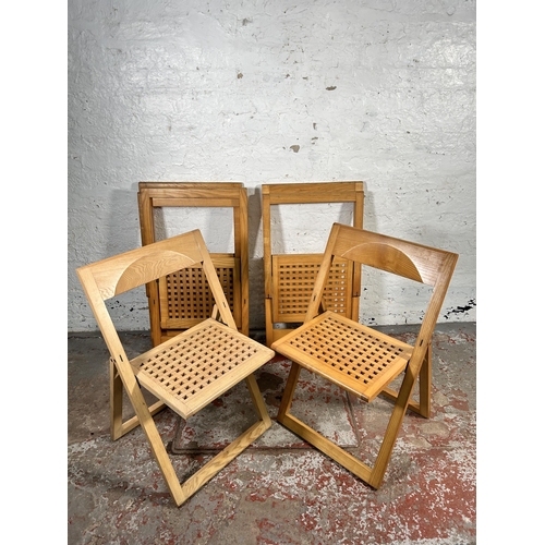 184 - Five contemporary oak folding chairs to include one stamped made in Italy by Magis