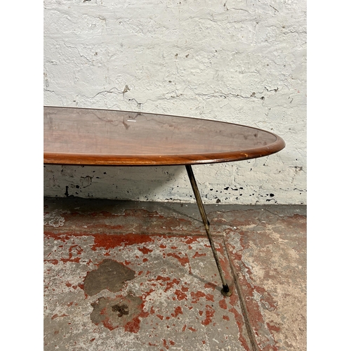 187 - A mid 20th century teak effect oval coffee table on hairpin supports - approx. 41cm high x 53cm wide... 