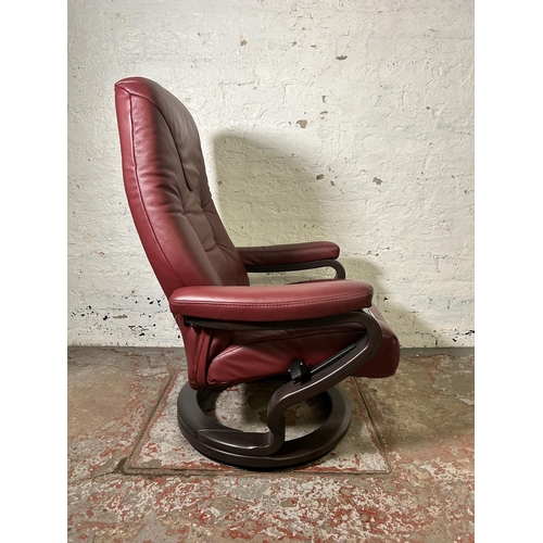 21 - A Himolla oxblood leather and bentwood swivel reclining armchair