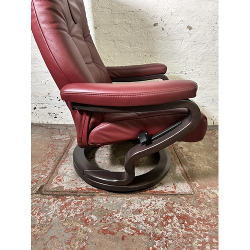 21 - A Himolla oxblood leather and bentwood swivel reclining armchair