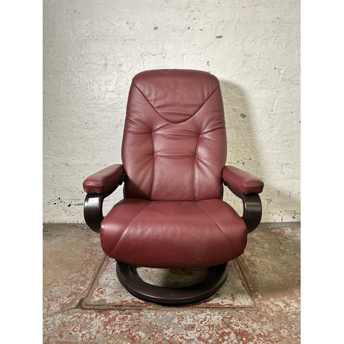 21 - A Himolla oxblood leather and bentwood swivel reclining armchair