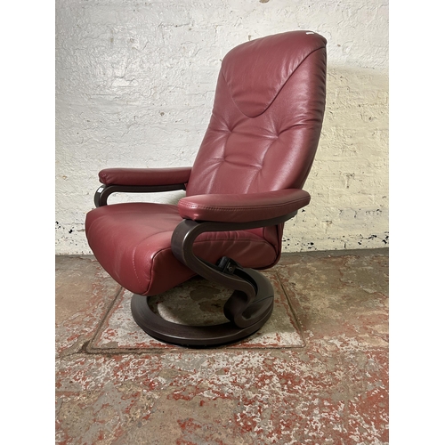 21 - A Himolla oxblood leather and bentwood swivel reclining armchair