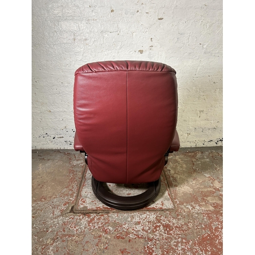 21 - A Himolla oxblood leather and bentwood swivel reclining armchair