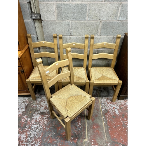 29 - Four beech and rush seated ladder back dining chairs