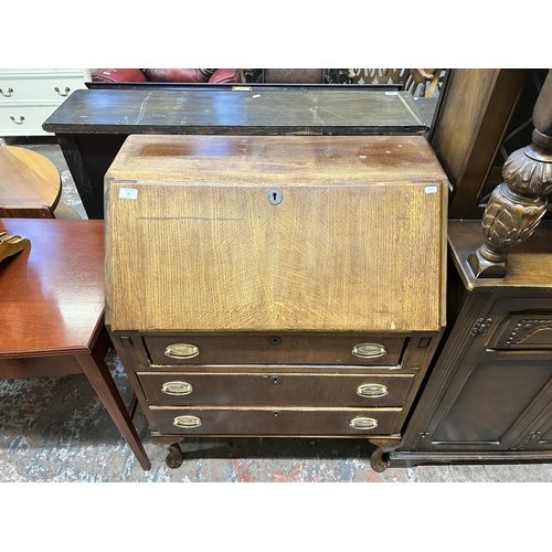 32 - A mid 20th century oak bureau on cabriole supports