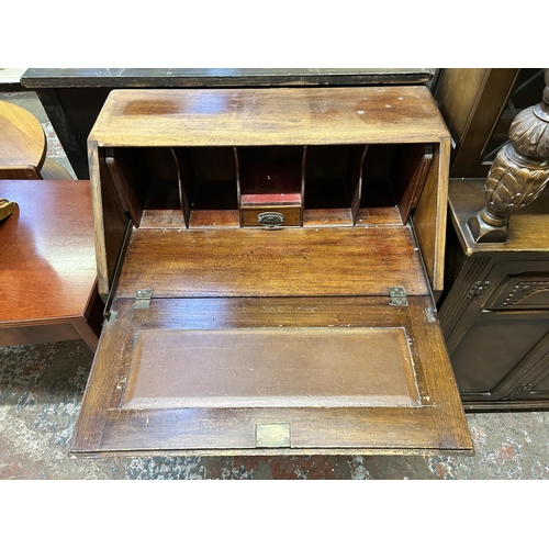 32 - A mid 20th century oak bureau on cabriole supports