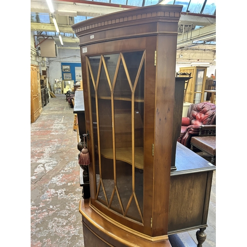 34 - A Georgian style yew wood free standing corner cabinet