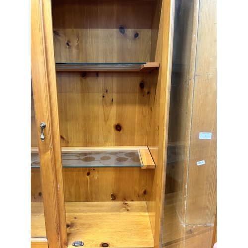 4 - A modern pine display cabinet - approx. 204cm high x 142cm wide x 50cm deep