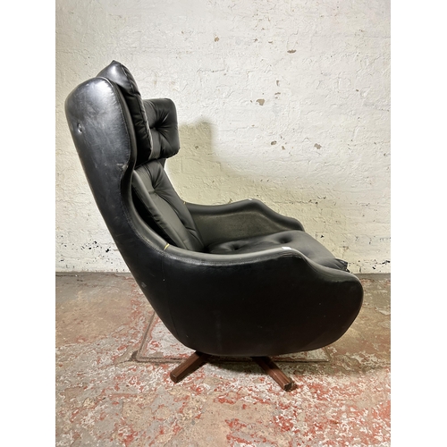 45 - A mid 20th century Parker Knoll Statesman black vinyl and teak swivel armchair