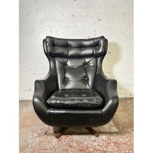 46 - A mid 20th century Parker Knoll Statesman black vinyl and teak swivel armchair