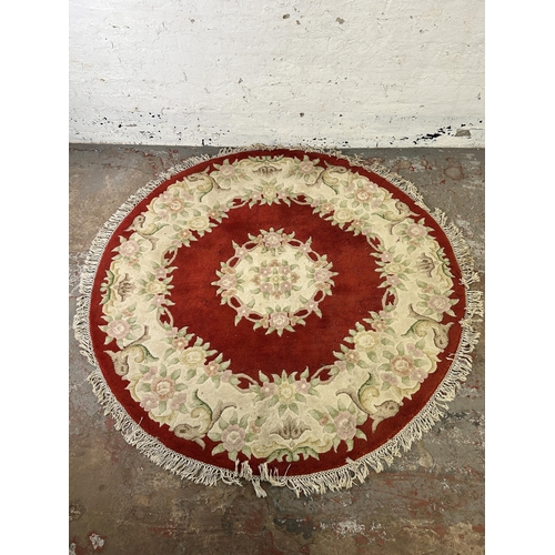 48 - A late 20th century red floral pattern circular rug - approx. 183cm diameter