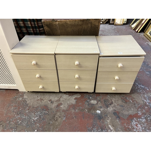 51 - Three late 20th century wood effect bedside chests of drawers