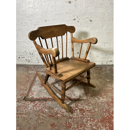 59 - A mid 20th century beech spindle back rocking chair