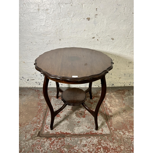 62 - An Edwardian mahogany serpentine two tier occasional table