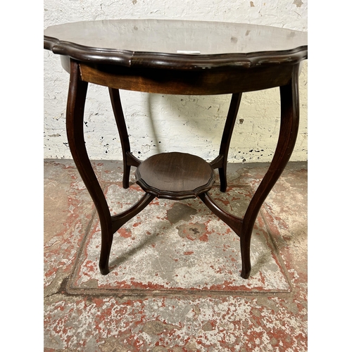 62 - An Edwardian mahogany serpentine two tier occasional table