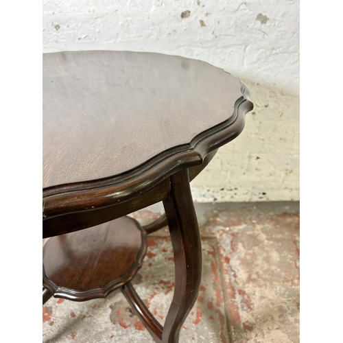 62 - An Edwardian mahogany serpentine two tier occasional table