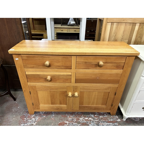 65 - A modern oak sideboard - approx. 90cm high x 120cm wide x 37cm deep