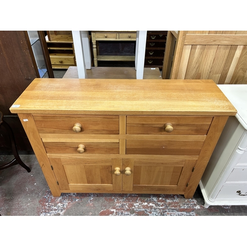 65 - A modern oak sideboard - approx. 90cm high x 120cm wide x 37cm deep