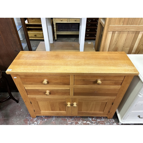 65 - A modern oak sideboard - approx. 90cm high x 120cm wide x 37cm deep