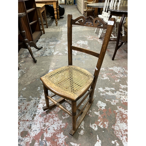 66 - An Edwardian carved beech and rattan rocking chair