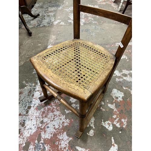 66 - An Edwardian carved beech and rattan rocking chair