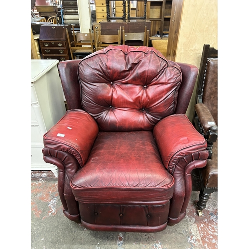 67 - An oxblood leather reclining armchair