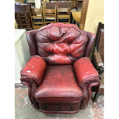 67 - An oxblood leather reclining armchair