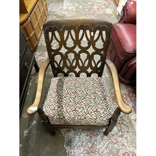 69 - A mid 20th century beech armchair with fabric upholstered cushion