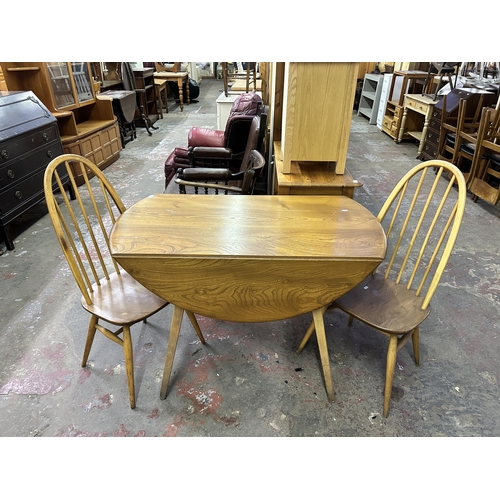 70 - A 1960s Ercol Windsor blonde elm and beech drop leaf dining table and two Quaker dining chairs - tab... 