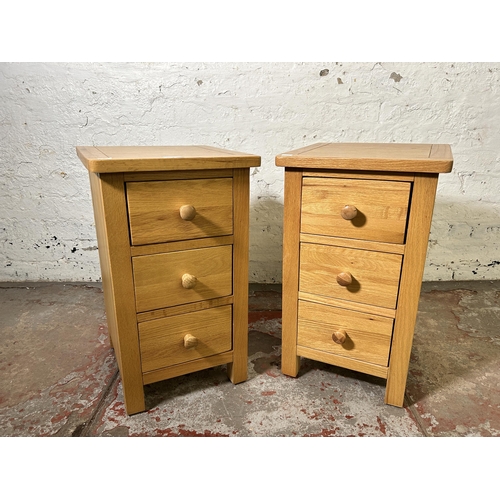 72 - A pair of modern oak bedside chests of drawers - approx. 57cm high x 34cm wide x 35cm deep