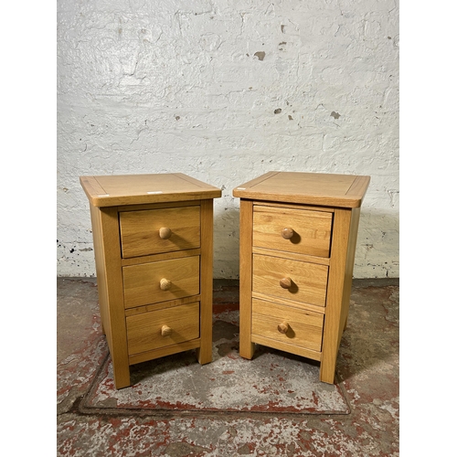 72 - A pair of modern oak bedside chests of drawers - approx. 57cm high x 34cm wide x 35cm deep