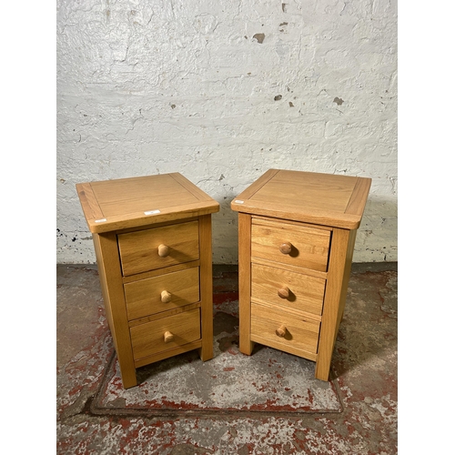 72 - A pair of modern oak bedside chests of drawers - approx. 57cm high x 34cm wide x 35cm deep