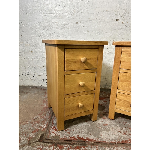 72 - A pair of modern oak bedside chests of drawers - approx. 57cm high x 34cm wide x 35cm deep