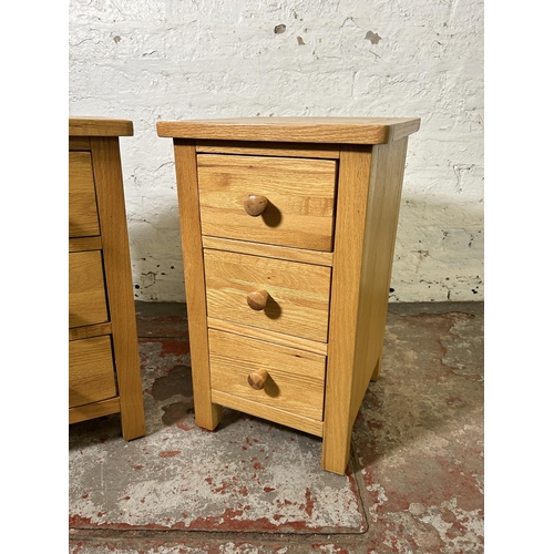 72 - A pair of modern oak bedside chests of drawers - approx. 57cm high x 34cm wide x 35cm deep