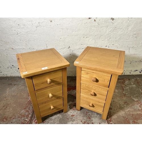 72 - A pair of modern oak bedside chests of drawers - approx. 57cm high x 34cm wide x 35cm deep