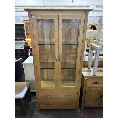 77 - A modern oak display cabinet - approx. 180cm high x 87cm wide x 39cm deep