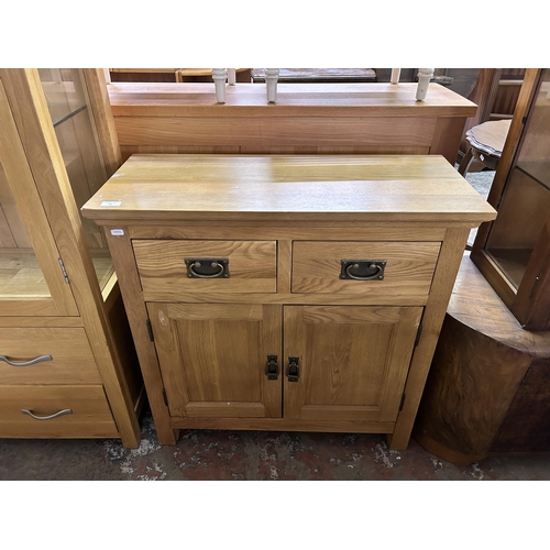 79 - A modern oak sideboard - approx. 80cm high x 80cm wide x 34cm deep