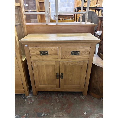 79 - A modern oak sideboard - approx. 80cm high x 80cm wide x 34cm deep