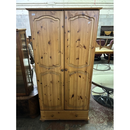 81 - A pine double wardrobe - approx. 180cm high x 88cm wide x 57cm deep