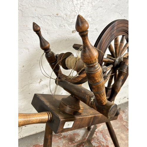 98 - A Victorian style elm and beech spinning wheel - approx. 81cm high x 76cm long