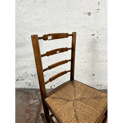 195 - A 19th century ash and elm rush seated ladder back rocking chair