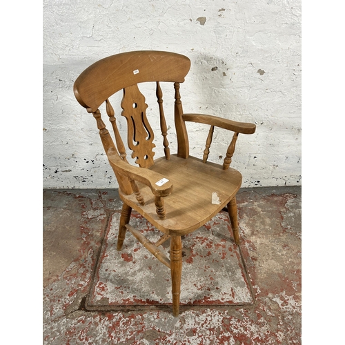 199 - A Victorian style beech farmhouse armchair