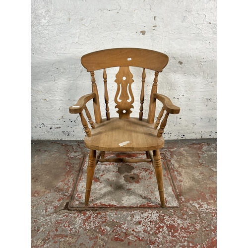 199 - A Victorian style beech farmhouse armchair