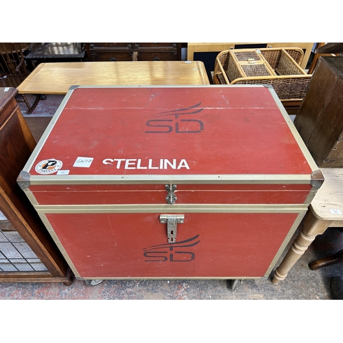 211 - A red painted and metal banded storage trunk on castors - approx. 92cm high x 101cm wide x 66cm deep