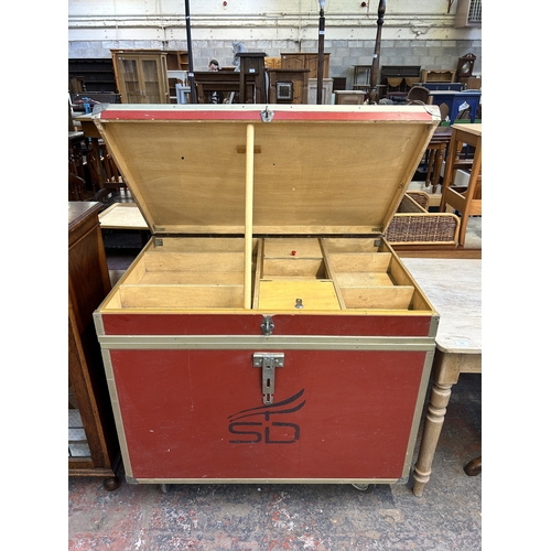 211 - A red painted and metal banded storage trunk on castors - approx. 92cm high x 101cm wide x 66cm deep