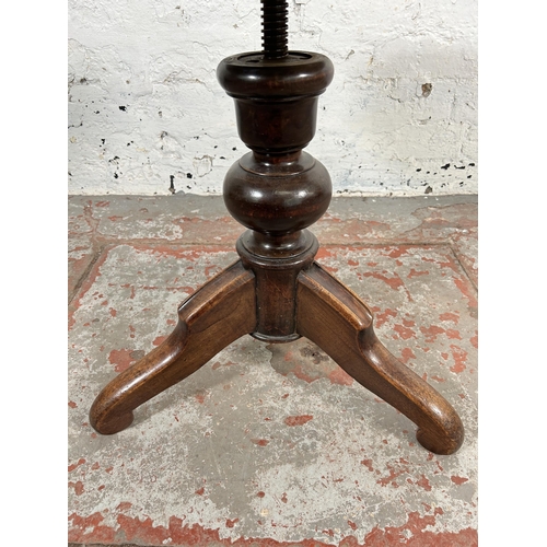 214 - A late 19th/early 20th century beech and cane adjustable piano stool - approx. 50cm high x 39cm in d... 